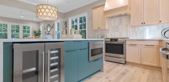 Verbena model home kitchen with blue kitchen island and wood cabinetry Parade of Homes